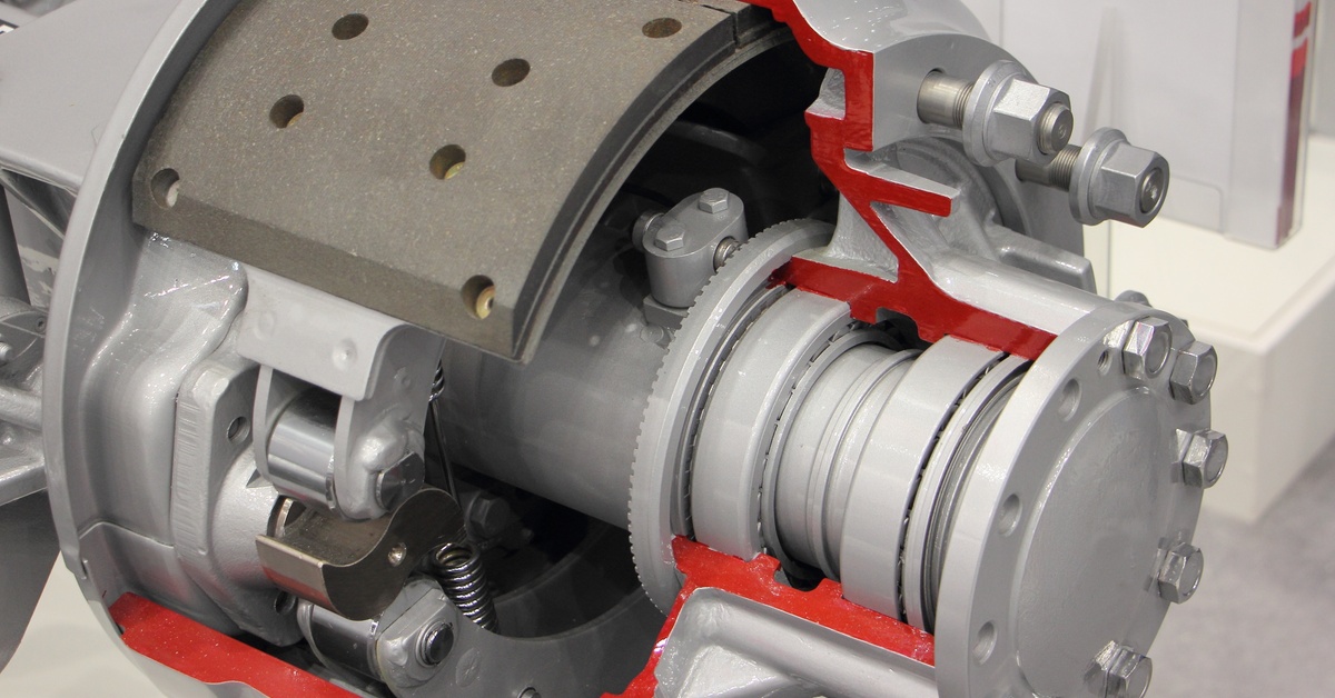 A silver mechanical assembly with red-highlighted sections, showing gears, a brake pad, and internal parts.