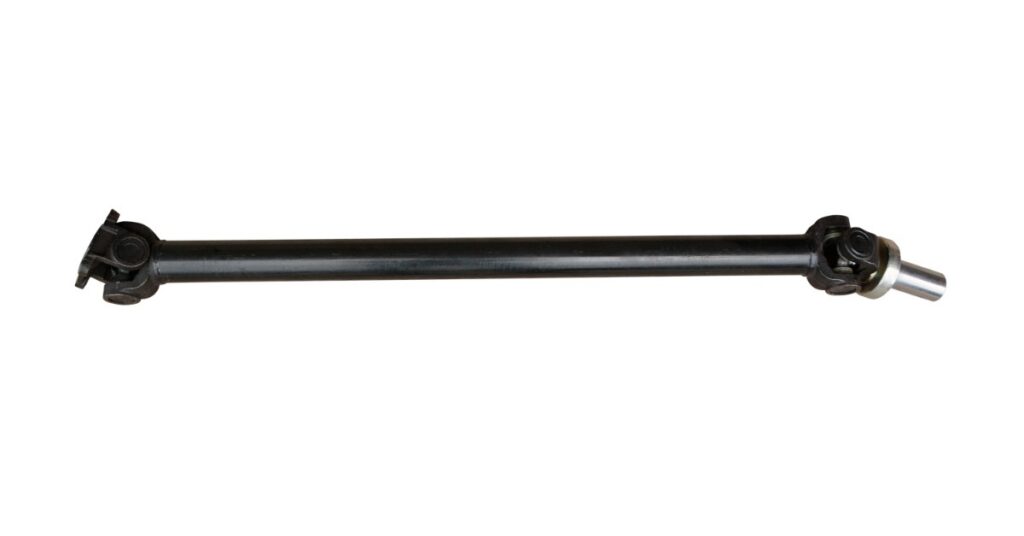 A long, black driveshaft for off-highway equipment is positioned horizontally on an isolated white background.